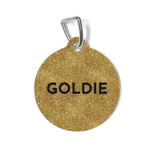 Round gold glitter personalized dog tag with the name Goldie in bold black capitals