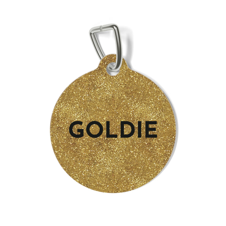 Round gold glitter personalized dog tag with the name Goldie in bold black capitals