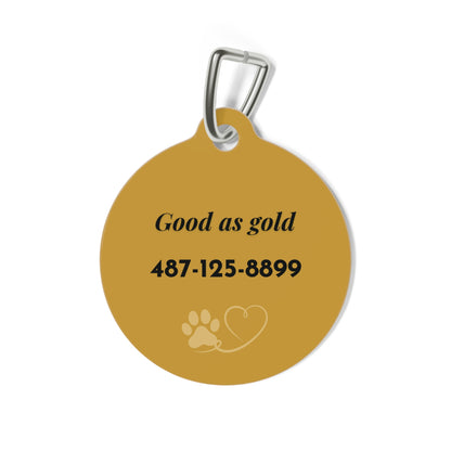Back of the gold paw print dog tag with the funny text Good as gold and a phone number