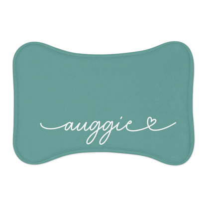 Jade bone-shaped personalized pet feeding mat with the name Auggie in white handwritten script and a small heart