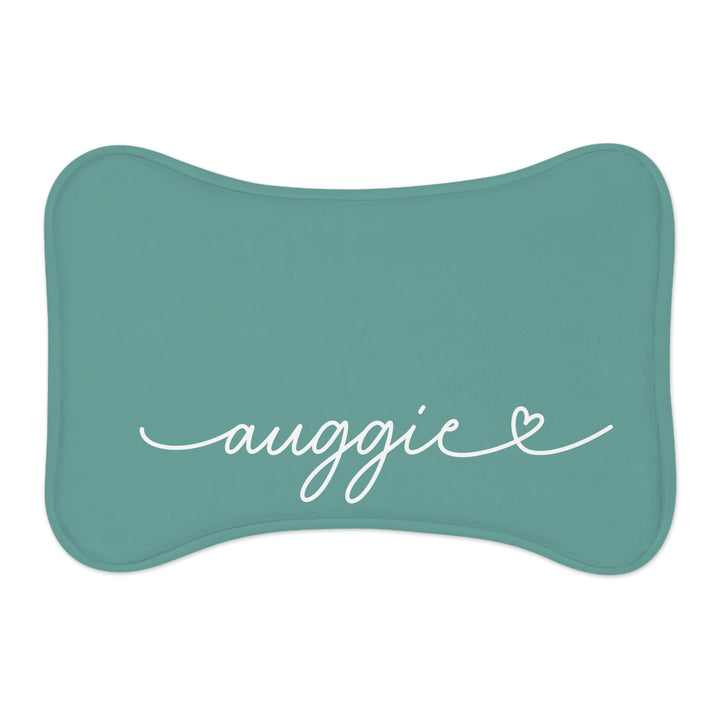 Jade bone-shaped personalized pet feeding mat with the name Auggie in white handwritten script and a small heart