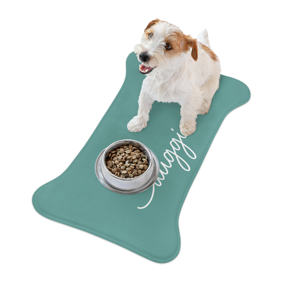 Jack Russell terrier standing on a jade bone-shaped personalized pet feeding mat next to a food bowl