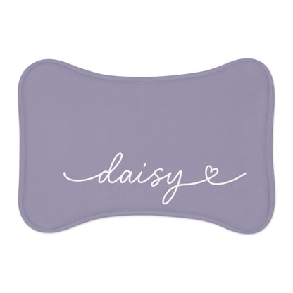 Lavender bone-shaped personalized pet feeding mat with the name Daisy in white handwritten script and a small heart