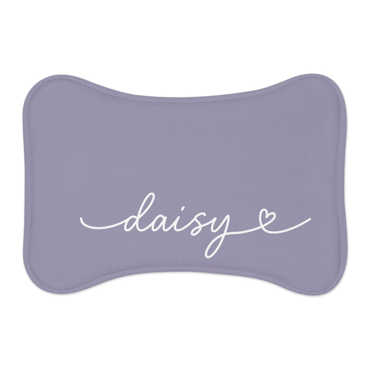 Lavender bone-shaped personalized pet feeding mat with the name Daisy in white handwritten script and a small heart