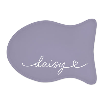 Lavender fish-shaped personalized pet feeding mat with the name Daisy in white handwritten script