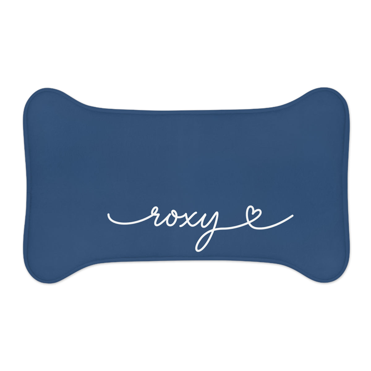 Small midnight blue bone-shaped personalized pet feeding mat with the name Roxy in white script