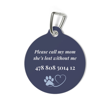 Back of the navy blue personalized pet tag with a contact message, phone number and paw print with heart