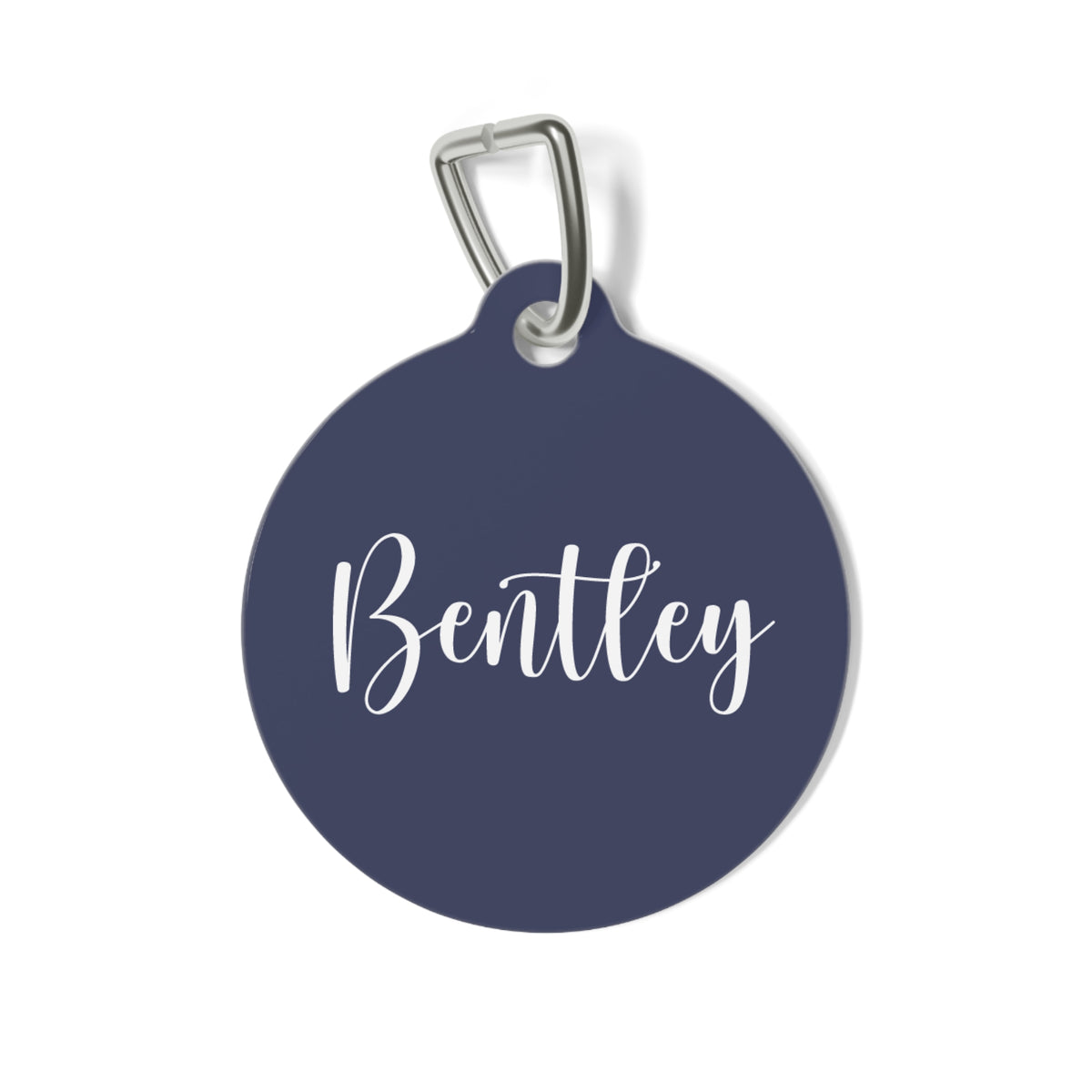 Round navy blue personalized pet tag with the name Bentley in white calligraphy script