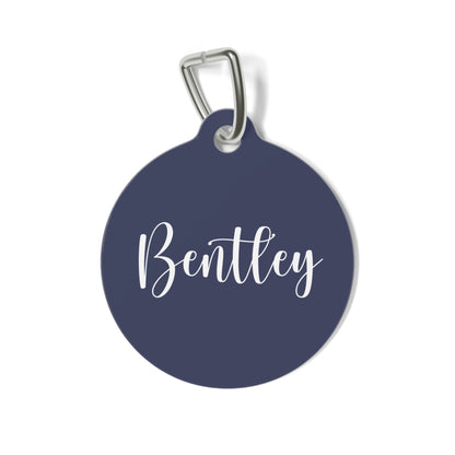 Round navy blue personalized pet tag with the name Bentley in white calligraphy script