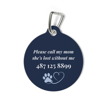 Back of the navy pet tag with printed contact message and a paw print