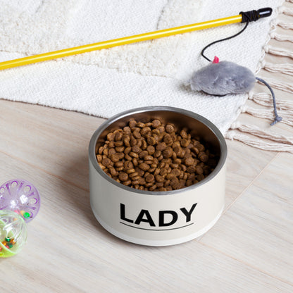 Off-white modern personalized dog bowl filled with kibble on a rug next to a pet toy