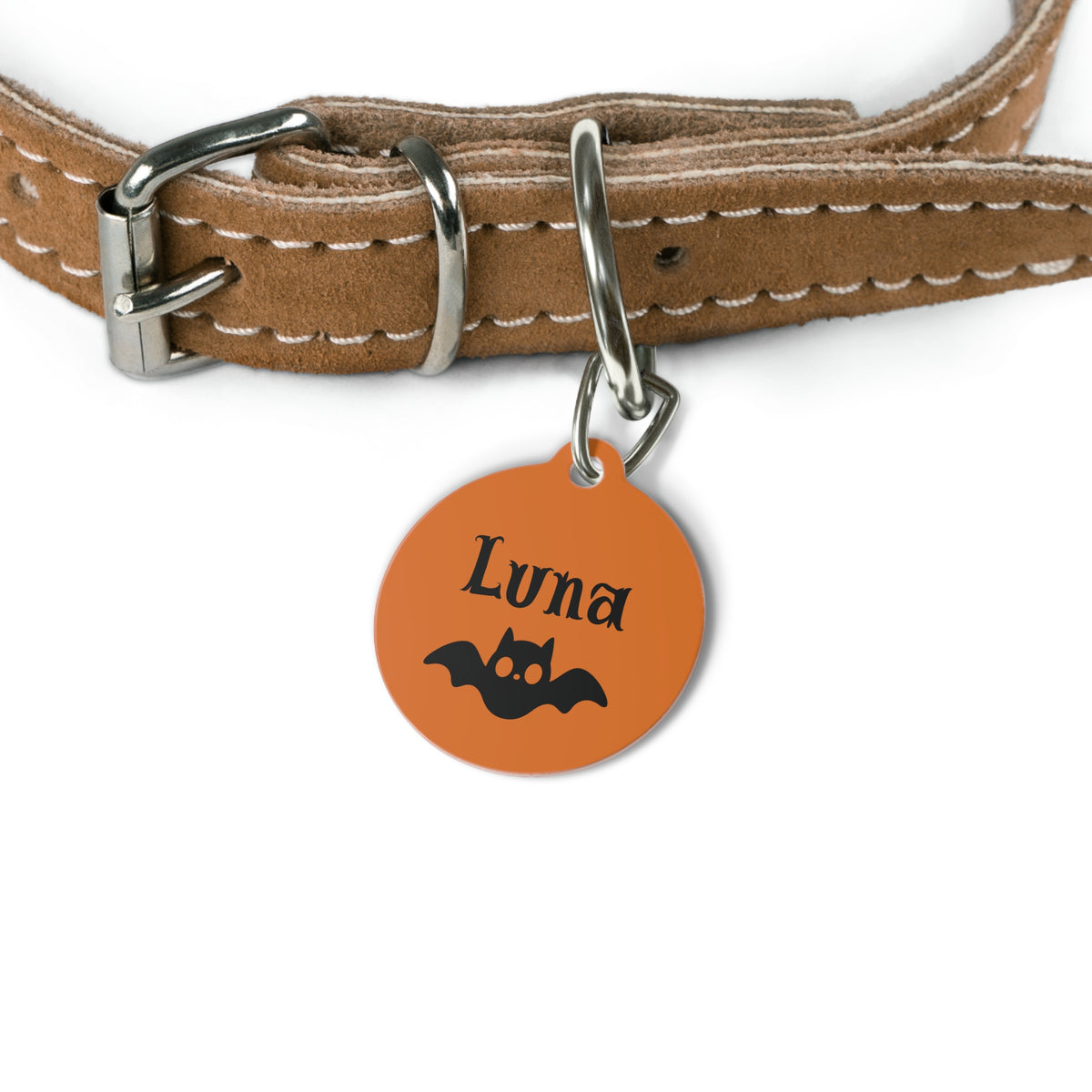 Orange bat personalized dog tag hanging from a tan leather dog collar