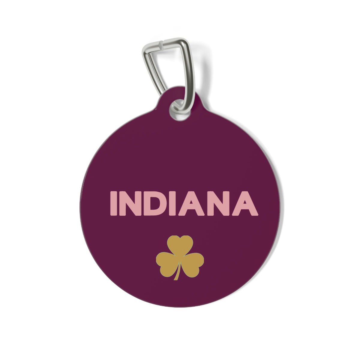 Burgundy personalized dog tag with the pet name in light lettering and a gold clover