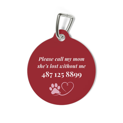 Back of the burgundy pet tag showing the contact message with paw and heart icons