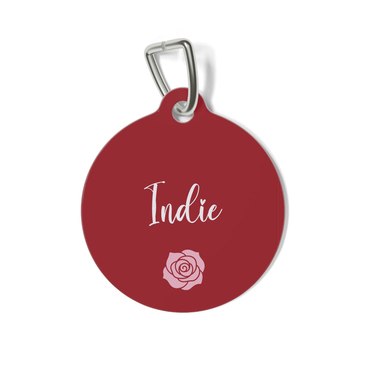 Burgundy personalized dog tag with the pet name in white script and a small rose below