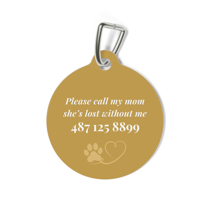Back of the golden pet tag showing the contact message with paw and heart icons