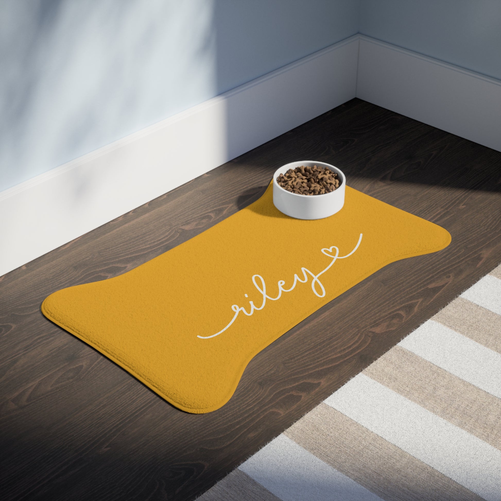 Personalized marigold dog food mat with a feeding bowl on a dark surface - alternate angle