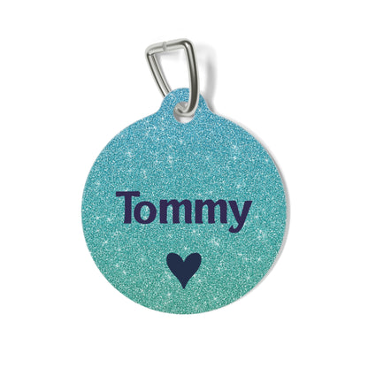Metallic teal personalized dog tag with the pet name in navy lettering and a small heart