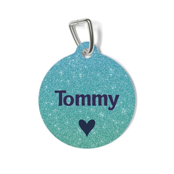 Metallic teal personalized dog tag with the pet name in navy lettering and a small heart
