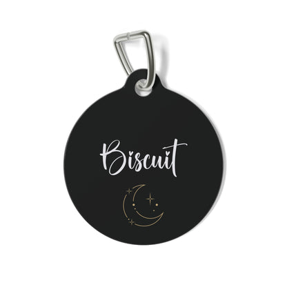 Black personalized pet tag with pet's name in white script and a gold moon and stars design