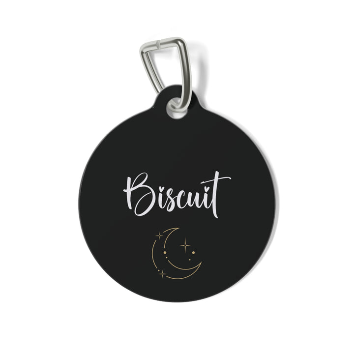 Black personalized pet tag with pet's name in white script and a gold moon and stars design