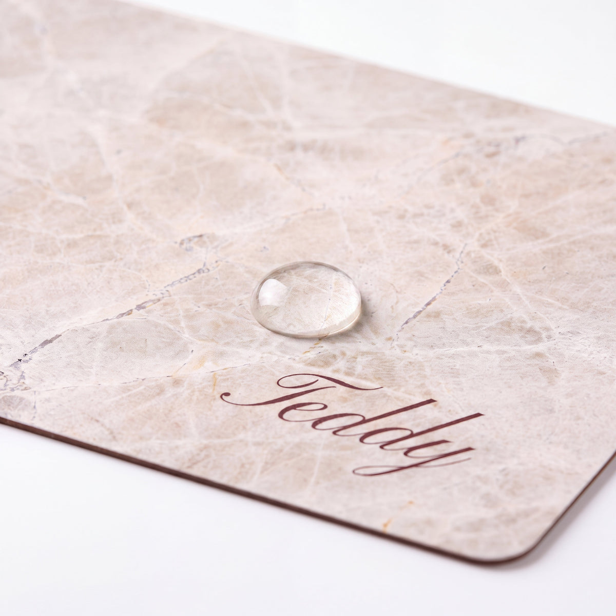 Close-up of a water droplet resting on the surface of a personalized pet food mat