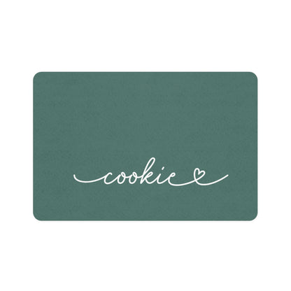 Pine green rectangle personalized pet food mat with the name Cookie in white handwritten script and a small heart