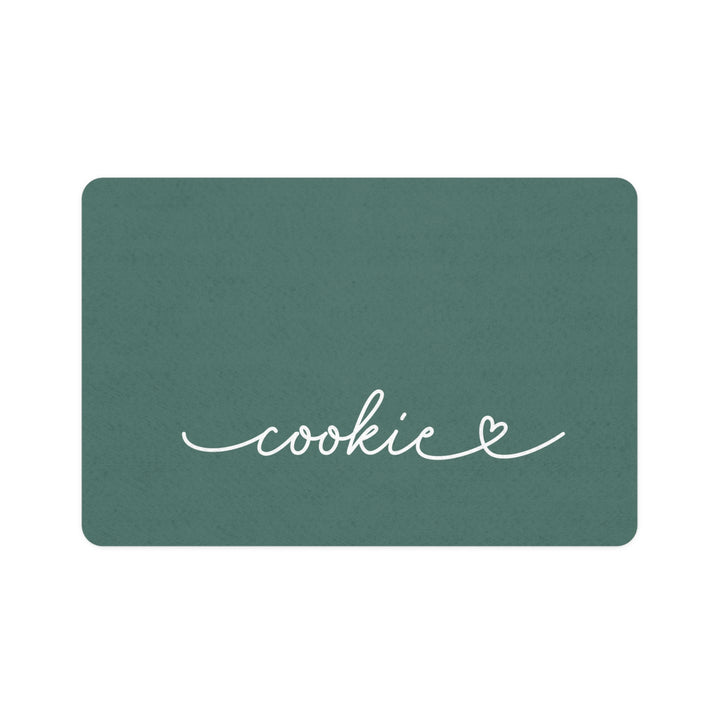 Pine green rectangle personalized pet food mat with the name Cookie in white handwritten script and a small heart