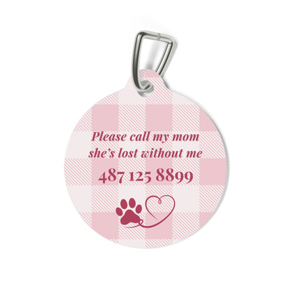 Back of the pink checkered pet tag with printed contact message and a paw print