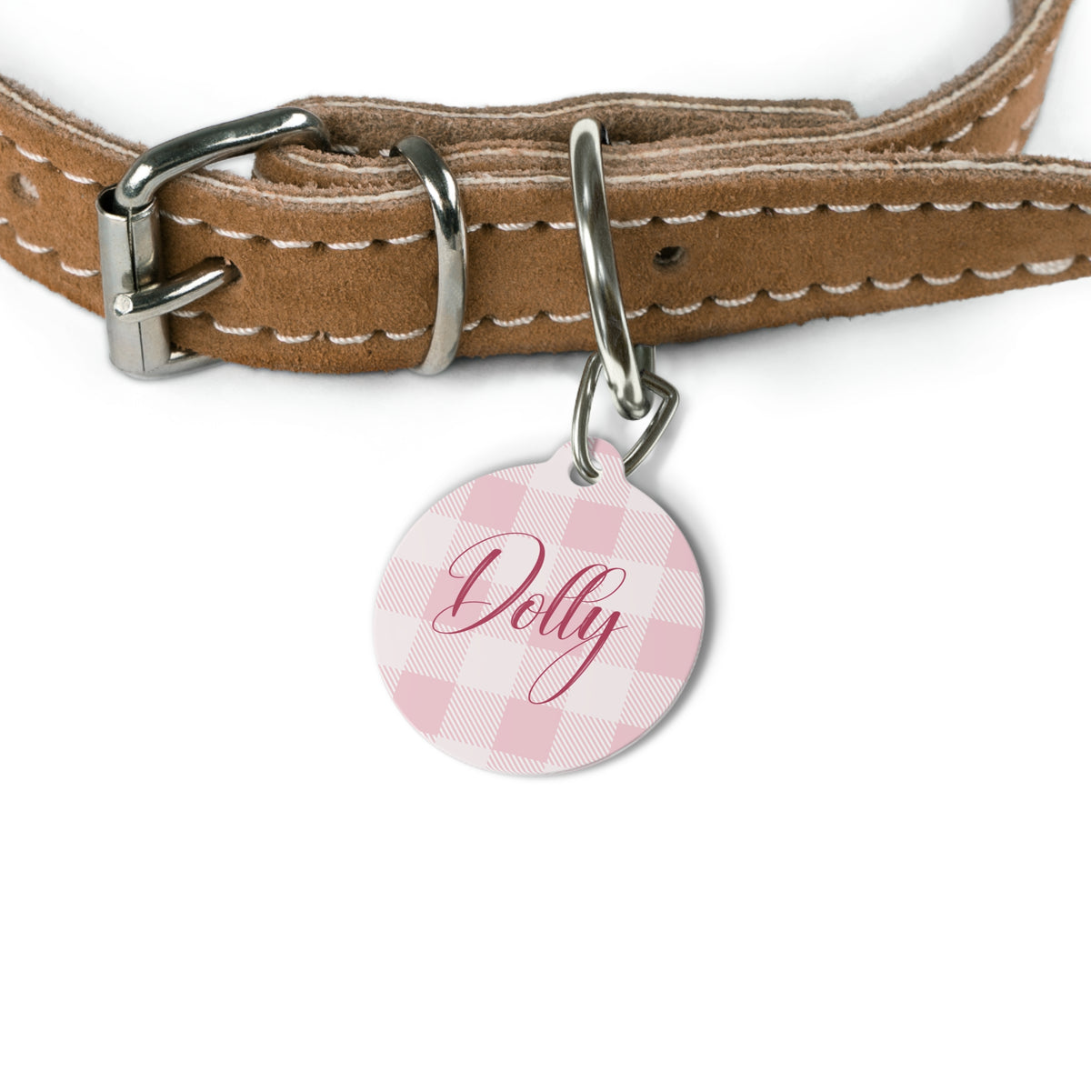 Pink checkered pet tag attached to a tan leather dog collar