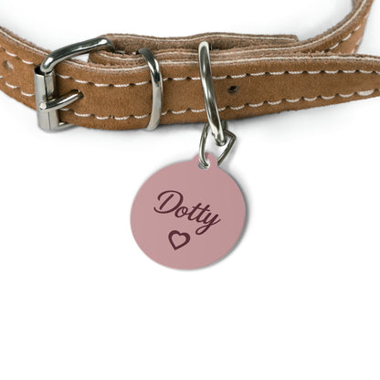 Pink heart pet tag on a tan leather collar