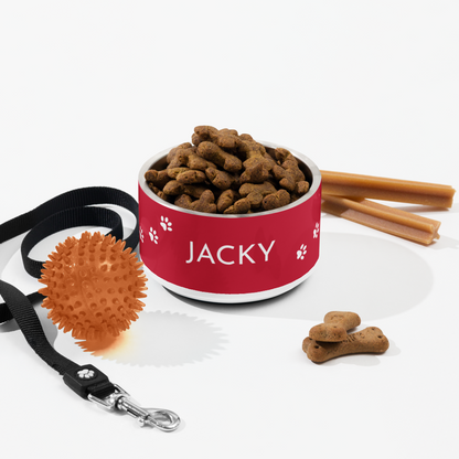 Red paw print personalized dog bowl with kibble styled with a leash, toy and cinnamon sticks