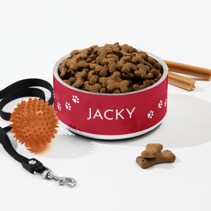 Flat lay of a red paw print personalized dog bowl with kibble, leash and cinnamon sticks