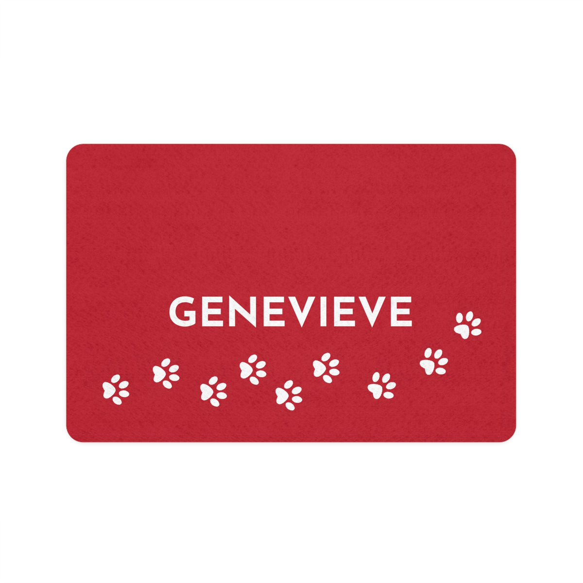 Red personalized dog food mat with the name Genevieve in white letters and a trail of white paw prints