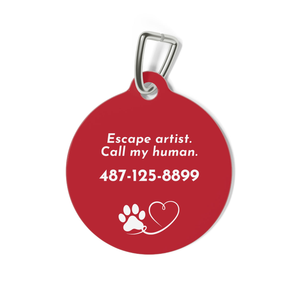 Back of red personalized dog tag with funny text Escape artist, call my human, a phone number, a paw and a heart