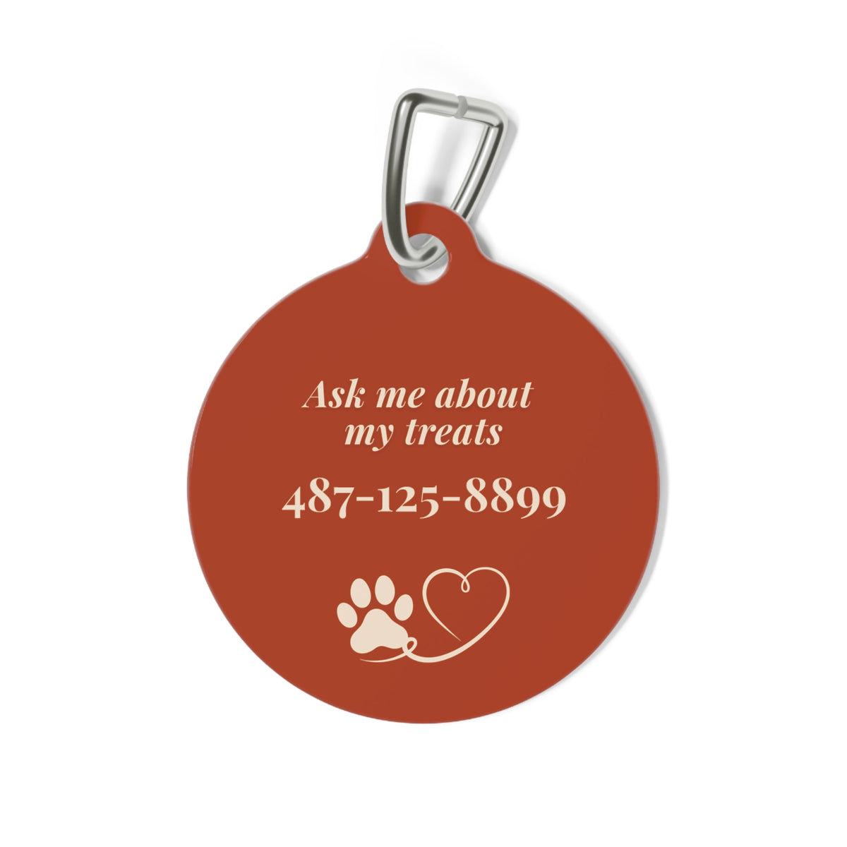Back of rust pumpkin personalized dog tag with Ask me about my treats, phone number and a paw and heart