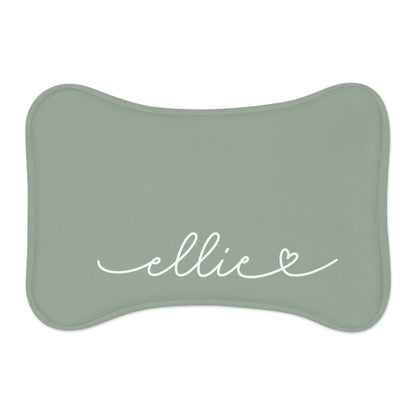 Sage green bone-shaped personalized pet feeding mat with the name Ellie in white handwritten script and a small heart