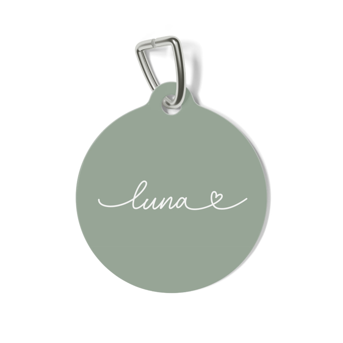 Round sage green personalized pet tag with the name Luna in white handwritten script and a small heart