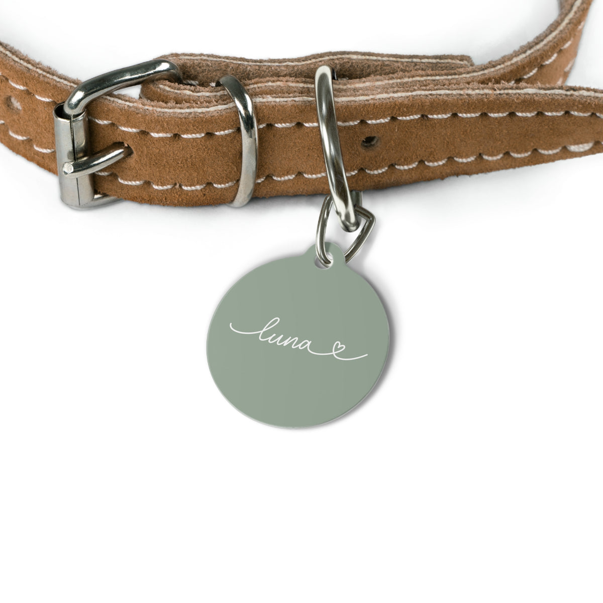 Sage green personalized pet tag hanging from a tan leather dog collar