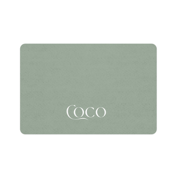 Soft sage rectangle personalized pet food mat with the name Coco in white serif lettering