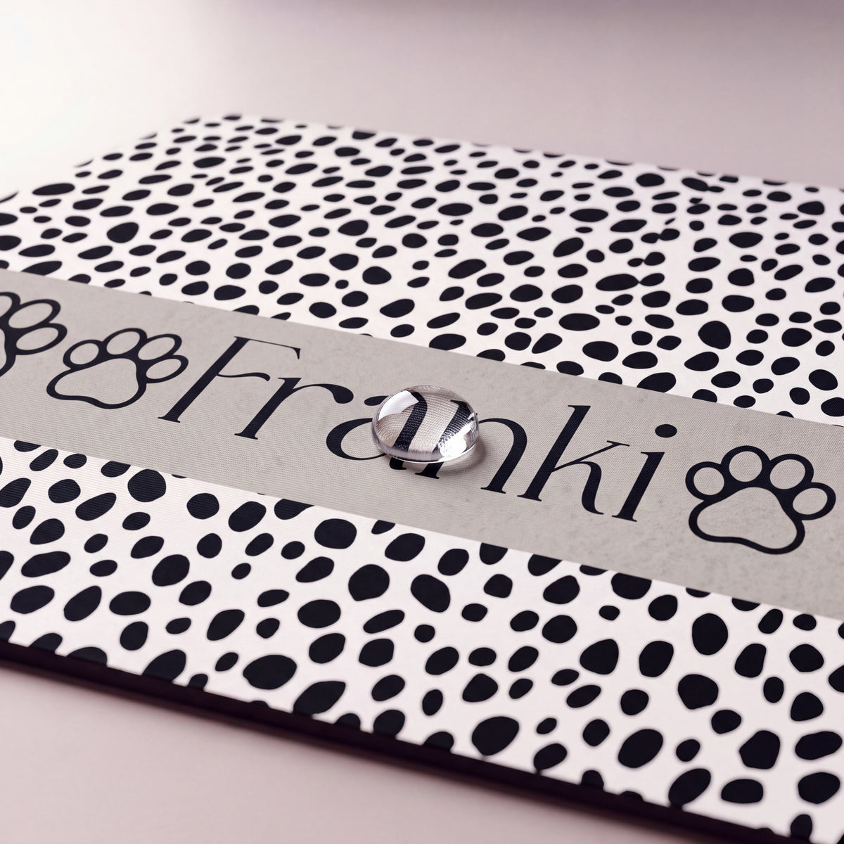 Close-up of the spotted paw personalized pet food mat showing the name Franki between paw prints