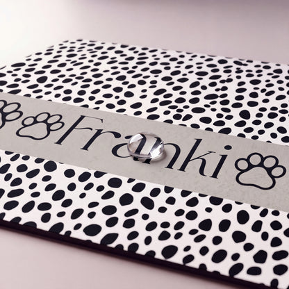 Close-up of the spotted paw personalized pet food mat showing the name Franki between paw prints