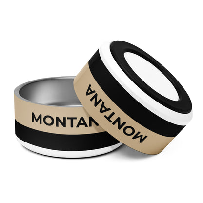 Two large tan and black two-tone personalized dog bowls with the name Montana, one tilted to show the rim